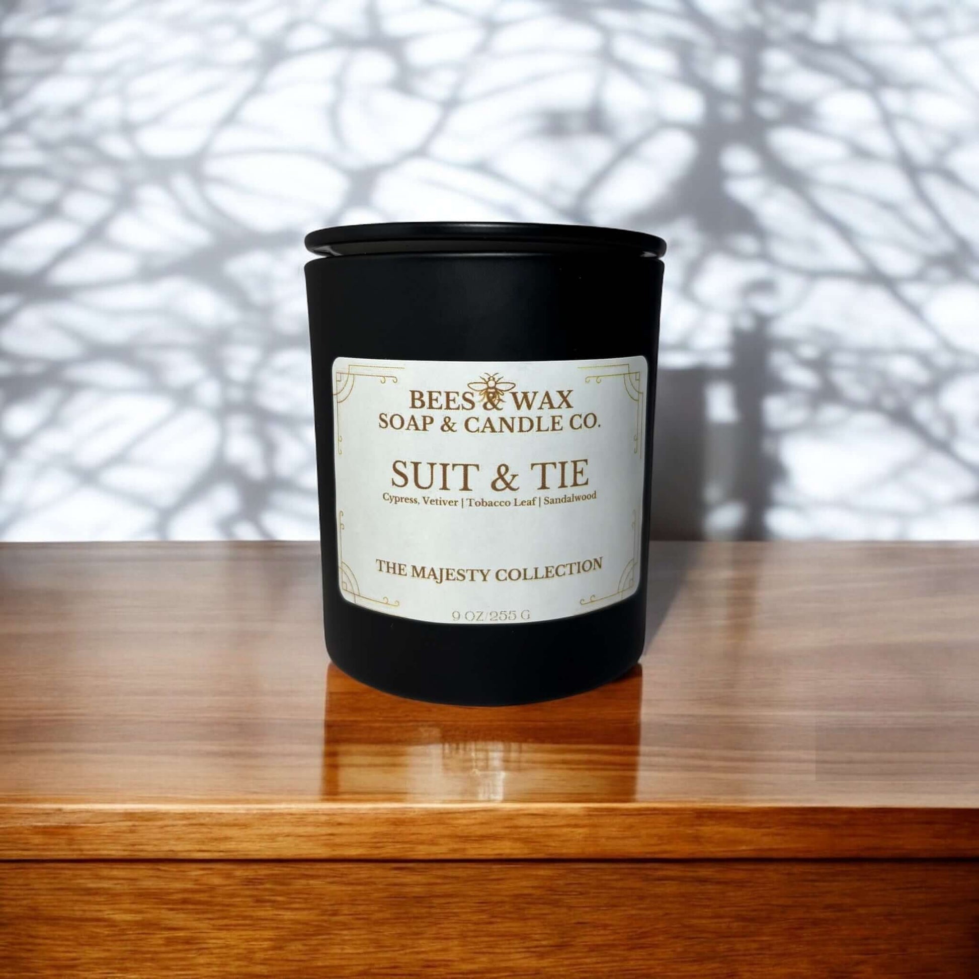 Bees & Wax Majesty Collection candle in black jar, featuring Suit & Tie fragrance with creamy vanilla and smokey tobacco.
